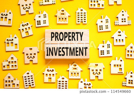 Property investment symbol. Concept words Property investment on beautiful wooden blocks. Wooden model of houses. Beautiful yellow background. Business Property investment concept. Copy space. Property investment symbol. Concept words Property investment on beautiful wooden blocks. Wooden model of houses. Beautiful yellow background. Business Property investment concept. Copy space. 114549660