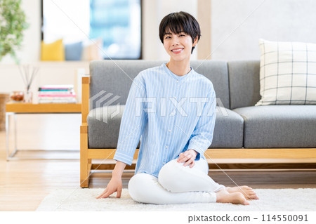 A woman relaxing in the living room. 114550091