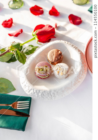 A stack of macarons. Spring composition of macarons with flowers. A stack of macarons. Spring composition of macarons with flowers. 114550100
