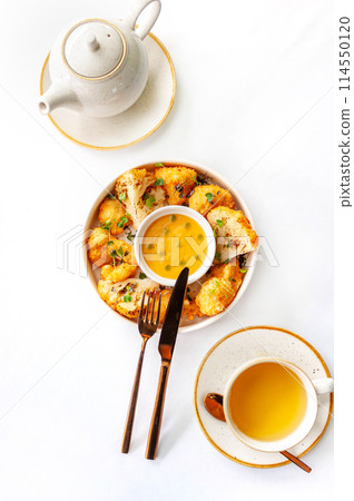 Light breakfast in a restaurant with green tea and baked cauliflower Light breakfast in a restaurant with green tea and baked cauliflower 114550120