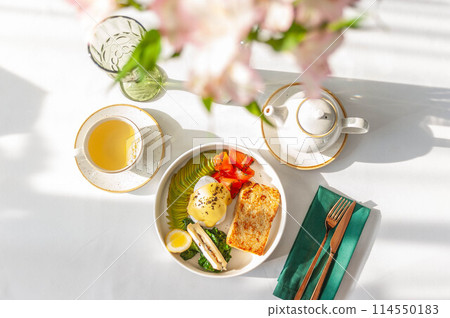 Light breakfast in a restaurant with green tea, toast, egg, avocado and salmon Light breakfast in a restaurant with green tea, toast, egg, avocado and salmon 114550183