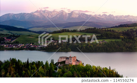 Medieval Castle in Niedzica by the lake and far view of the Tatra mountains. Medieval Castle in Niedzica by the lake and far view of the Tatra mountains. 114550274