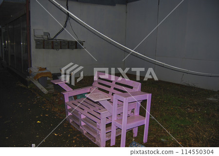 Place to relax and smoke.Pink bench with cup holders made from wooden pallets. Place to relax and smoke.Pink bench with cup holders made from wooden pallets. 114550304