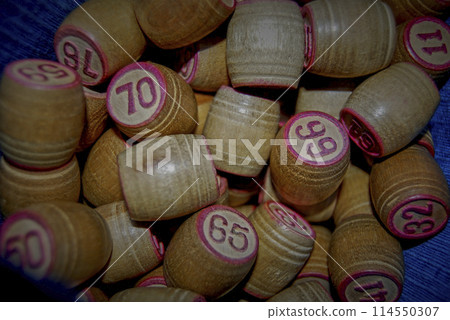 Lotto. Board game. Cards with numbers are covered with barrels.The barrels in the bag are mixed and taken out one at a time, announced and the numbers on the cards are covered. Lotto. Board game. Cards with numbers are covered with barrels.The barrels in the bag are mixed and taken out one at a time, announced and the numbers on the cards are covered. 114550307