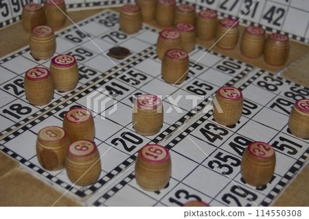Lotto. Board game. Cards with numbers are covered with barrels.The barrels in the bag are mixed and taken out one at a time, announced and the numbers on the cards are covered. Lotto. Board game. Cards with numbers are covered with barrels.The barrels in the bag are mixed and taken out one at a time, announced and the numbers on the cards are covered. 114550308