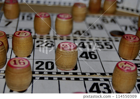 Lotto. Board game. Cards with numbers are covered with barrels.The barrels in the bag are mixed and taken out one at a time, announced and the numbers on the cards are covered. 114550309