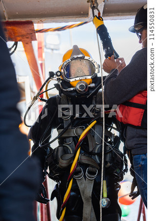 Commercial diver geared up for underwater work 114550831