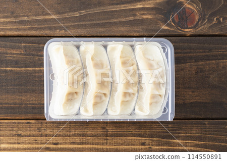 Frozen dumplings on wood background 114550891
