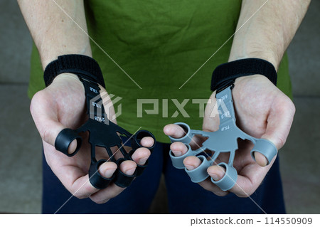 Finger trainer for two hands of man made of silicone with tension force marks for training the strength of the hands and fingers, treating diseases of the joints of the hands 114550909