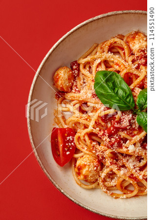 Arrabbiata pasta with tomato sauce, meatballs, parmesan and basil Arrabbiata pasta with tomato sauce, meatballs, parmesan and basil 114551490