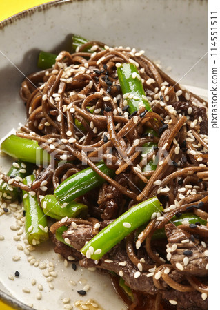 Asian stir-fried soba noodles with beef and green beans 114551511