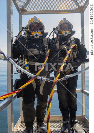 Commercial diver prepared for deep water entry Commercial diver prepared for deep water entry 114551568