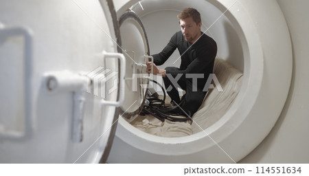 Military man receiving treatment in industrial hyperbaric chamber Military man receiving treatment in industrial hyperbaric chamber 114551634