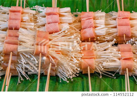 grilled mushrooms, bacon, put on grill at Thai street food market, selective focus 114552112