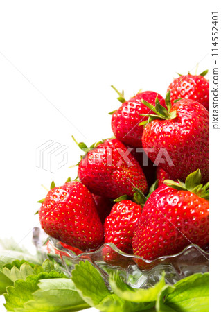 Ripe tasty strawberries in a glass vase with green leaves Ripe tasty strawberries in a glass vase with green leaves 114552401