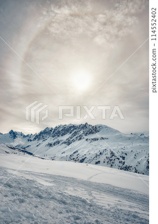 Sun halo over snowy mountains in the French Alps Sun halo over snowy mountains in the French Alps 114552402