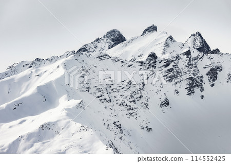 Snow-covered mountain peak in a winter landscape 114552425