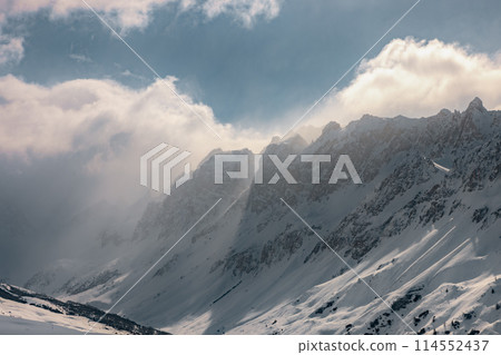 Sunlight beams through snowy peaks of French Alps Sunlight beams through snowy peaks of French Alps 114552437