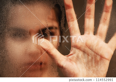 Woman touching steamy shower glass with hand 114552991