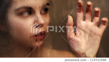 Woman touching steamy shower glass with hand 114552996
