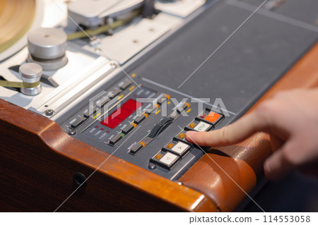 Woman operating vintage tape recorder Woman operating vintage tape recorder 114553058