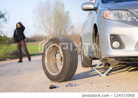 Car tire under maintenance after blowout at pitstop Car tire under maintenance after blowout at pitstop 114553068
