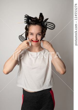 beautiful brunette housewife girl with kitchen utensils in her hair instead of curlers 114553274