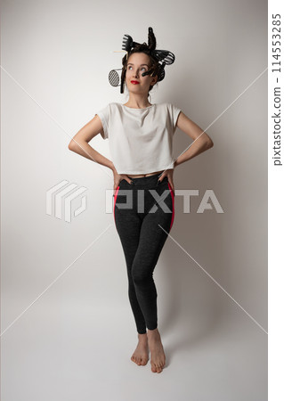 beautiful brunette housewife girl with kitchen utensils in her hair instead of curlers 114553285