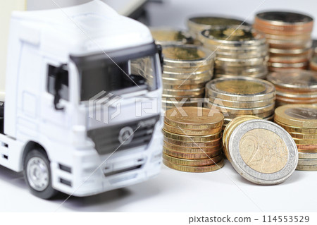 White Container Truck with pile of coins, business and financial concept. White Container Truck with pile of coins, business and financial concept. 114553529