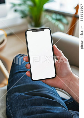 Man's hand holding mockup blank mobile phone screen 114553597