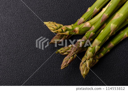 Sprigs of raw green asparagus as an ingredient for preparing a healthy breakfast Sprigs of raw green asparagus as an ingredient for preparing a healthy breakfast 114553812