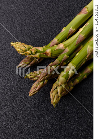 Sprigs of raw green asparagus as an ingredient for preparing a healthy breakfast 114553813