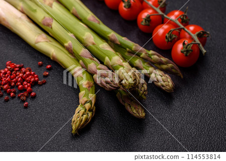 Sprigs of raw green asparagus as an ingredient for preparing a healthy breakfast Sprigs of raw green asparagus as an ingredient for preparing a healthy breakfast 114553814
