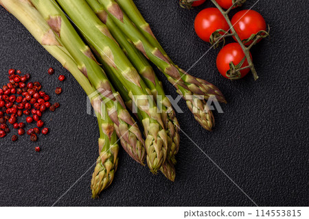 Sprigs of raw green asparagus as an ingredient for preparing a healthy breakfast Sprigs of raw green asparagus as an ingredient for preparing a healthy breakfast 114553815