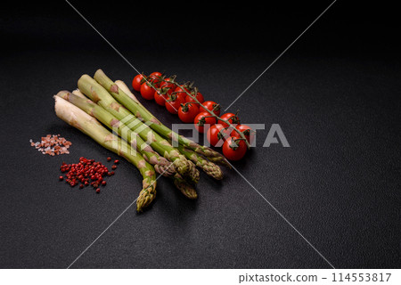 Sprigs of raw green asparagus as an ingredient for preparing a healthy breakfast Sprigs of raw green asparagus as an ingredient for preparing a healthy breakfast 114553817