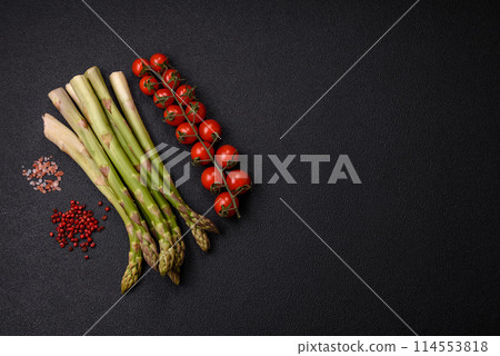 Sprigs of raw green asparagus as an ingredient for preparing a healthy breakfast Sprigs of raw green asparagus as an ingredient for preparing a healthy breakfast 114553818