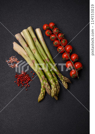 Sprigs of raw green asparagus as an ingredient for preparing a healthy breakfast Sprigs of raw green asparagus as an ingredient for preparing a healthy breakfast 114553819