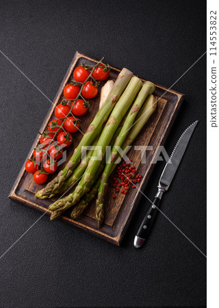 Sprigs of raw green asparagus as an ingredient for preparing a healthy breakfast 114553822