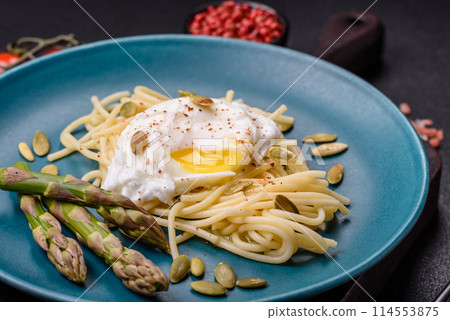 Delicious hearty breakfast consisting of poached eggs on toast with cream cheese, asparagus 114553875