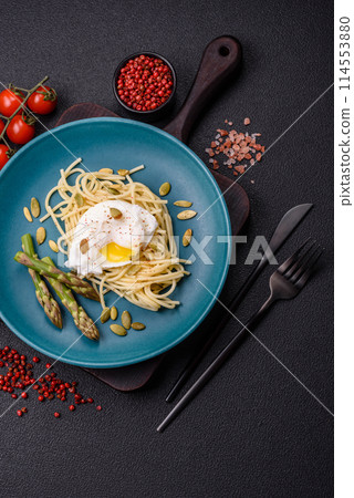 Delicious hearty breakfast consisting of poached eggs on toast with cream cheese, asparagus Delicious hearty breakfast consisting of poached eggs on toast with cream cheese, asparagus 114553880