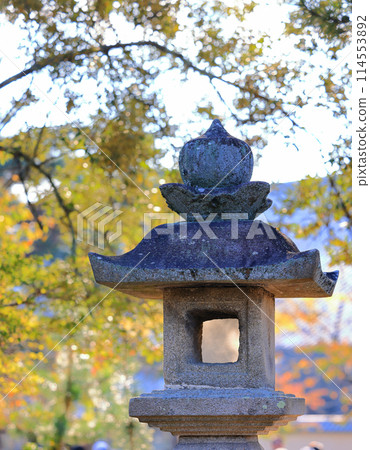 Japanese stone lantern in the garden, beautiful Autumn scenery in Japan. Japanese stone lantern in the garden, beautiful Autumn scenery in Japan. 114553892