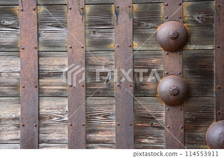 Rusted stake of ancient door lock on old wooden main shrine door. Rusted stake of ancient door lock on old wooden main shrine door. 114553911