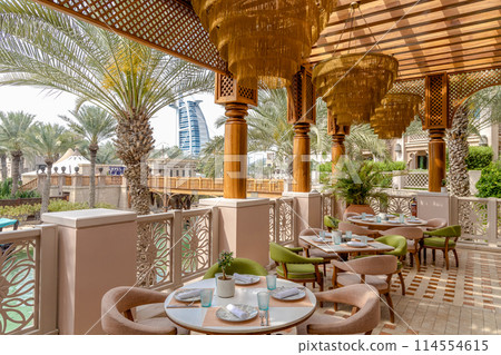 A restaurant with a view of the Burj al Arab in Dubai. 114554615