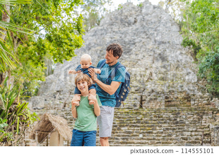 Dad with two sons tourists at Coba, Mexico. Ancient mayan city in Mexico. Coba is an archaeological area and a famous landmark of Yucatan Peninsula. Cloudy sky over a pyramid in Mexico Dad with two sons tourists at Coba, Mexico. Ancient mayan city in Mexico. Coba is an archaeological area and a famous landmark of Yucatan Peninsula. Cloudy sky over a pyramid in Mexico 114555101