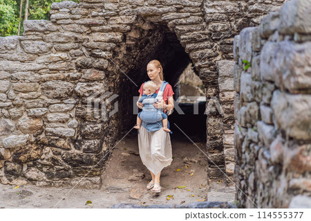 Mother and son tourists at Coba, Mexico. Ancient mayan city in Mexico. Coba is an archaeological area and a famous landmark of Yucatan Peninsula. Cloudy sky over a pyramid in Mexico Mother and son tourists at Coba, Mexico. Ancient mayan city in Mexico. Coba is an archaeological area and a famous landmark of Yucatan Peninsula. Cloudy sky over a pyramid in Mexico 114555377