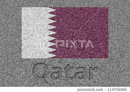 The Qatari flag painted on a stone slab with the word "Qatar" carved into it 114556066