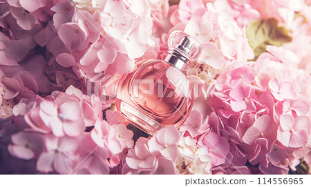 Perfume bottle with beautiful flowers. Floral background. Beauty concept. Flat lay, top view. Perfume bottle with beautiful flowers. Floral background. Beauty concept. Flat lay, top view. 114556965