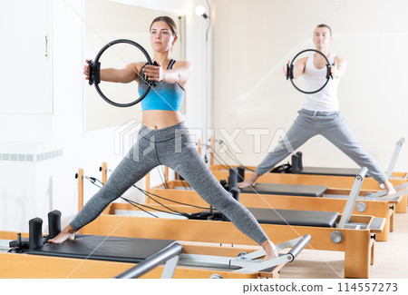 Girl restores her health with the help of gymnastic ring during Pilates classes 114557273