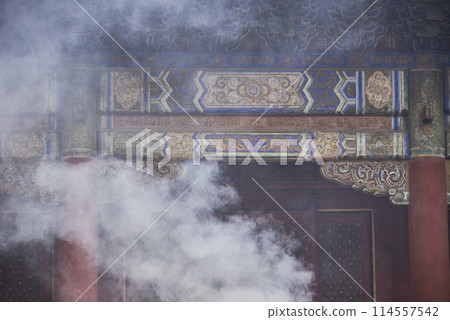 Incense smoke rising in Yonghe Temple of Tibetan Buddhism in Dongcheng District in Beijing, China 114557542