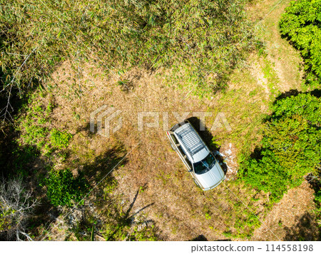 Top view Brown American SUV Jeep Grand Cherokee WJ 2002 on the dirt road in Phuket Thailand,Off-road in the forests 114558198